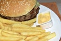 Triple meaty delicious hamburger with nice fries Royalty Free Stock Photo