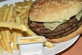 Triple meaty delicious hamburger with nice fries Royalty Free Stock Photo