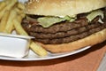 Triple meaty delicious hamburger with nice fries Royalty Free Stock Photo