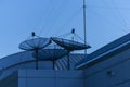Triple satellite dishs on the building roof. Royalty Free Stock Photo