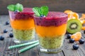 Triple smoothie in glass: kiwi-mint, mandarin-apricot and strawberry-blueberry Royalty Free Stock Photo