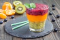 Triple smoothie in glass: kiwi-mint, mandarin-apricot and strawberry-blueberry Royalty Free Stock Photo
