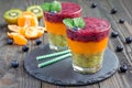 Triple smoothie in glass: kiwi-mint, mandarin-apricot and strawberry-blueberry Royalty Free Stock Photo