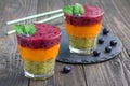 Triple smoothie in glass: kiwi-mint, mandarin-apricot and strawberry-blueberry Royalty Free Stock Photo