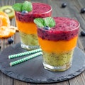 Triple smoothie in glass: kiwi mint, mandarin apricot and strawberry blueberry, square format Royalty Free Stock Photo