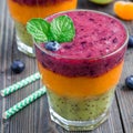 Triple smoothie in glass: kiwi mint, mandarin apricot and strawberry blueberry, square