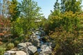 Triple waterfall splits into three streams in Japanese garden. Public landscape park of Krasnodar Royalty Free Stock Photo