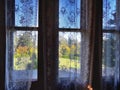 Triple window with fine netting curtain overlooking garden at Larnach Castle in New Zealand