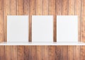 Triple 8x10 Vertical White Frame mockup on white shelf and rustic wooden wall Royalty Free Stock Photo