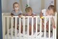 Triplets in crib, triplets baby Two boys and a girl - together