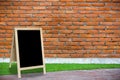 Tripod blackboard in interior room with molder brick wall