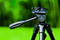 Tripod stand with blurred green backround Royalty Free Stock Photo