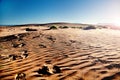 Trips and adventures. Morocco desert landscape and footprints in the sand. Scenic sunset Royalty Free Stock Photo