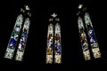 Triptych of stained-glass windows from St Patrick`s Cathedral on black background in Melbourne Australia