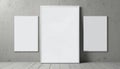 Triptych white frames of varying sizes arranged on a bare concrete wall for a clean, modern art display. Royalty Free Stock Photo