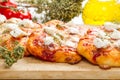 Tris of mixed pizza on wood with ingredients Royalty Free Stock Photo