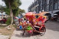 Trishaw decorated with colorful flowers on the street in Malacca