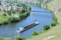 Trittenheim, Germany - 06 01 2021: Big cargo ship and small boat on the Mosel