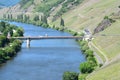 Trittenheim, Germany - 06 01 2021: Mosel valley with blue Mosel and traffic on the steep road and the river Royalty Free Stock Photo
