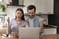 Family couple screaming of joy by laptop screen on kitchen Royalty Free Stock Photo