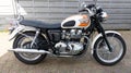 Triumph bonneville t100 motorcycle side view with sign text and logo brand on fuel tank