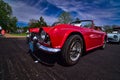 Classic 1964 Triumph TR4 convertible on blacktop at the lake mills car show at Ryans auto care