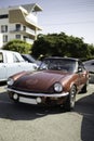 The Triumph Spitfire - British two-seat vintage sports car on a city street.