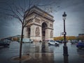 Triumphal Arch Arc de triomphe in Paris, France. Rainy autumn day with a romantic view to the historic landmark from avenue