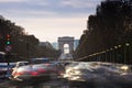 Triumphal Arch and Champ Elysses with moving cars in Paris Royalty Free Stock Photo