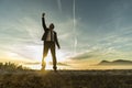 Triumphant businessman greeting a new day Royalty Free Stock Photo