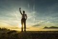 Triumphant businessman in white shirt standing outdoors with his