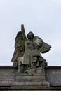 A triumphant stone angel sits on top of a large structure