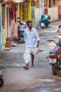 Trivandrum, India - February 17, 2016: happy man in lungi dhotis walks in the street