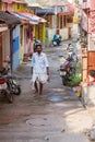 Trivandrum, India - February 17, 2016: happy man in lungi dhotis walks in the street