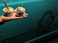 28/12/2018- Trivandrum, India: Hand of a person holding two small scoops of Chocholate ice cream in from Ice Cream Truck named