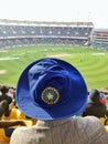 11/01/2018-Trivandrum, India: Man Watching a Cricket Match wearing Blue Indian Cricket Association Cap supporting Team India in