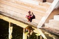 Old man wearing typical robe siting at Sree Padmanabhaswamy Temple pool during the sunny day in Trivandrum, India