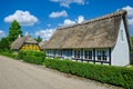 Troense, Denmark - June 26, 2016: Two idyllic half-timbered houses with thatched roof on a sunny day in the town