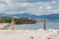 08-15-2015, Trogir, Croatia. Abandoned shipwreck washed ashore spoiling Adriatic Sea coastline.