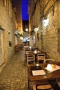 Restaurant in narrow streets of mediterranean city. Trogir at night. Croatia Royalty Free Stock Photo