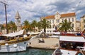 TROGIR, CROATIA sea promenade with an ancient building, palm and