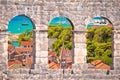 Trogir old city rooftops and turquoise archipelago view through stone windows Royalty Free Stock Photo