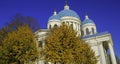 Troitsky Izmaylovsky cathedral with Autumn trees and blue sky background, in St. Petersburg, Russia