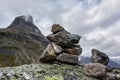 Troll rock pyramid with rainbow on top of Trollstigen road. Stone cairn Royalty Free Stock Photo