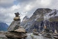 Troll rock pyramid with rainbow on top of Trollstigen road. Stone cairn