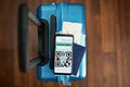 Trolley bag with smartphone and covid passport app