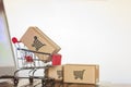 Trolley with boxes on laptop computer. Online shopping, e-commerce and worldwide shipping concept Royalty Free Stock Photo