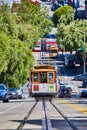 Trolley front and center with streetcar on bottom of hill and Clean Air Vehicle crossing road