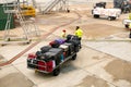 Trolley full of bags, suitcases and other luggage being loaded by ground crew