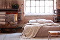 Trolley full of pillows next to a bed in a wabi sabi bedroom interior